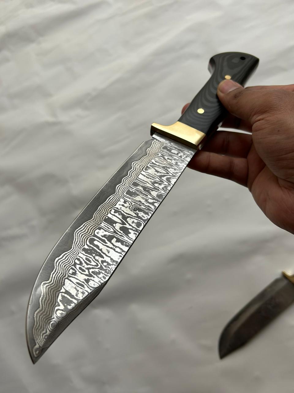 Damascus steel Bowie knife with Micarta handle and flowing pattern blade